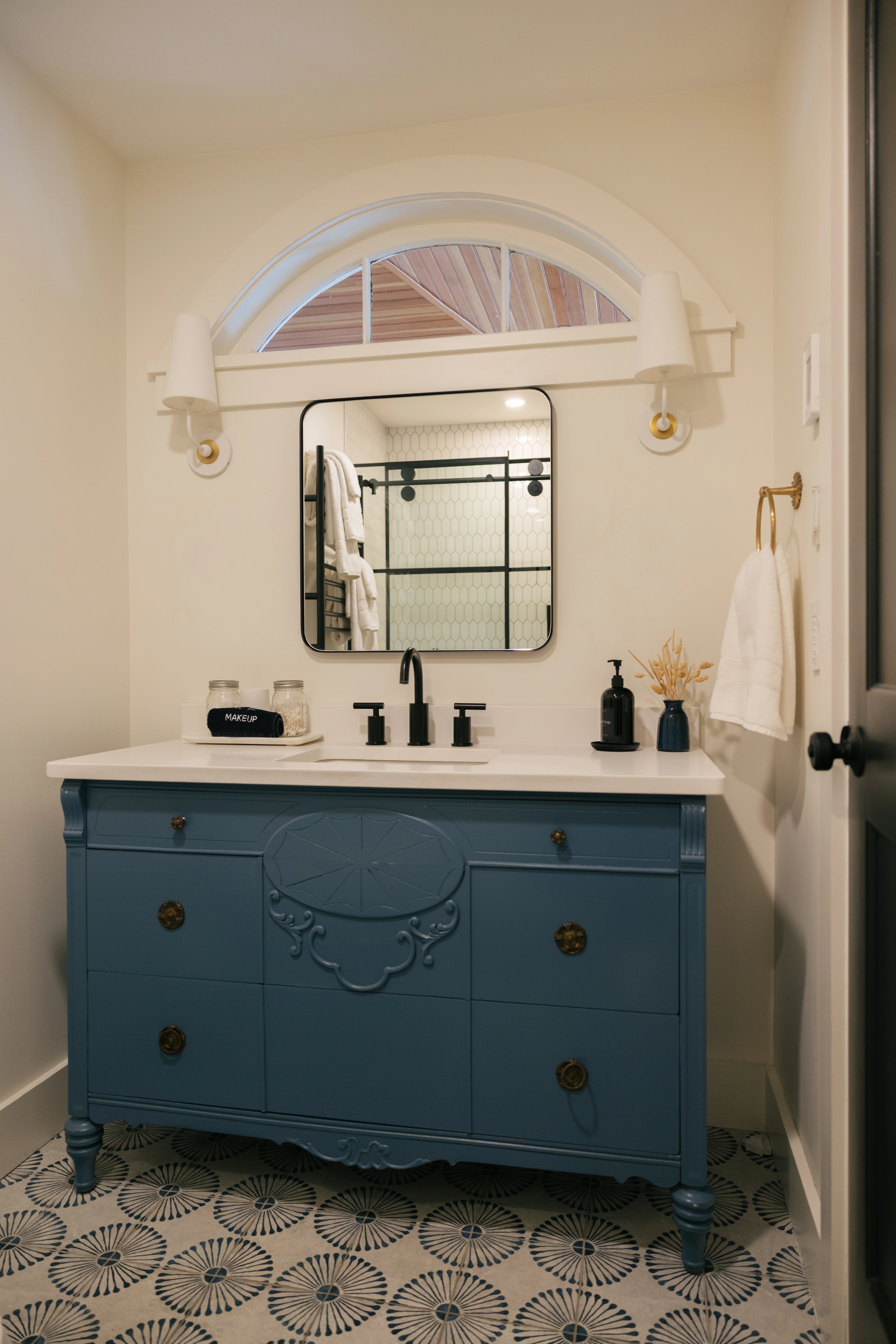 Second view of the downstairs king ensuite bathroom highlighting the shower and vanity details
